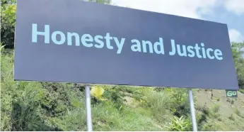  ??  ?? FijiFirst billboard - Honesty and Justice.