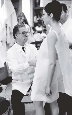  ?? (Photo courtesy of V&A) ?? Cristóbal Balenciaga fitting a model in his Paris atelier in 1968