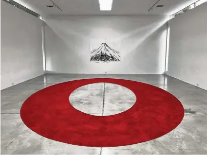  ?? Molly Glentzer / Houston Chronicle ?? “I am a very important person,” a custom-designed red carpet, fills a floor below a charcoal drawing on felt of Mount Fuji in Ariane Roesch’s solo show “V.I.P.” at Gallery Sonja Roesch.