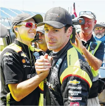  ?? AP PHOTO/CHARLIE NEIBERGALL ?? Simon Pagenaud celebrates with crew members Friday after winning the pole for today’s IndyCar Series race at Iowa Speedway in Newton.