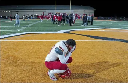  ?? Steve Mellon/Post-Gazette ?? Keith Pelmon pauses for a moment at midfield after Penn Hills’ loss to Moon in the WPIAL Class 5A semifinals Friday night at North Allegheny High School.