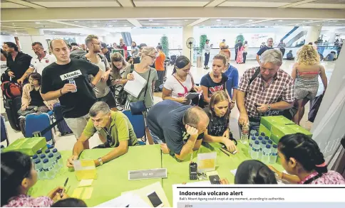  ??  ?? Passengers gather at the Ngurah Rai Internatio­nal airport in Denpasar, Bali to wait for possible flights out. — AFP photo