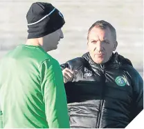  ??  ?? ■ Brendan Rodgers and Leigh Griffiths were well wrapped up at training during the week.