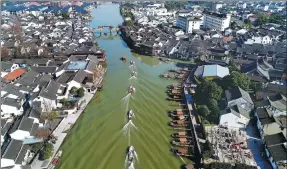  ?? PROVIDED TO CHINA DAILY ?? Members of a voluntary rescue team in Shanghai’s Zhujiajiao town patrol its waterways on charge
boats.