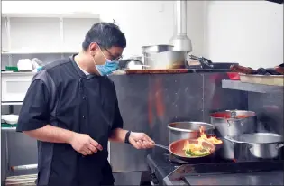  ?? NEWS PHOTO MO CRANKER ?? Hatter Sourav Saha cooks up a meal at his new restaurant called Rosewood Bistro.