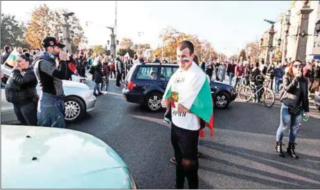  ?? AFP ?? A protestor holding the Bulgarian national flag while blocking a central boulevard during a protest against high fuel prices in Sofia… yesterday.