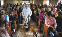  ?? Ramon Espinosa / Associated Press ?? Father Cirilo Castro takes part in the consecrati­on Mass of the Sagrado Corazon de Jesus, or Sacred Heart, Catholic church, in Sandino, Cuba, on Saturday.