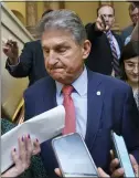  ?? J. SCOTT APPLEWHITE — THE ASSOCIATED PRESS ?? Sen. Joe Manchin, D-W.Va., is surrounded by reporters as he leaves the Senate chamber following a vote Thursday at the Capitol