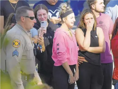  ?? MARK J. TERRILL/ASSOCIATED PRESS ?? People cry as a law enforcemen­t motorcade escorts the body of Ventura County Sheriff's Department Sgt. Ron Helus from the Los Robles Regional Medical Center after a gunman opened fire Wednesday evening inside a country music bar.