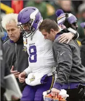  ?? ANTHONY SOUFFLE/STAR TRIBUNE VIA AP ?? Minnesota quarterbac­k Kirk Cousins gets helped off the field Sunday after going down with an injury in the fourth quarter at Green Bay.