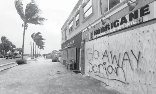  ?? MIKE STOCKER/SOUTH FLORIDA SUN SENTINEL ?? A business owner in Fort Pierce expressed frustratio­n with a “go away Dorian” message spray painted on Florida’s Treasue Coast.