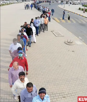  ??  ?? KUWAIT Testing times: People queue up and wait three feet apart from each other at a medical testing centre in Hawalli as the Gulf state goes into lockdown