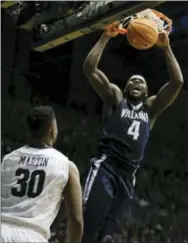  ?? AJ MAST — THE ASSOCIATED PRESS ?? Villanova forward Eric Paschall (4) dunks in front of Butler forward Kelan Martin (30) in the second half of an NCAA college basketball game in Indianapol­is, Saturday. Butler won 101-93.