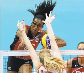  ?? MATT ROURKE/ASSOCIATED PRESS ?? Foluke Akinradewo, top, spikes the ball as Brankica Mihajlovic blocks during a women’s semifinal volleyball match Thursday at the 2016 Summer Olympics in Rio de Janeiro.