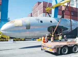  ?? (Yoram Dori; Maapilim.org) ?? THE FUSELAGE of a C-46 similar to those that brought Iraqi Jews to British Mandate Palestine (below, right) is offloaded after arriving at Haifa Port on Tuesday.