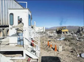  ?? JEFF SCHEID/LAS VEGAS REVIEW-JOURNAL ?? A worker watches a garbage hauler back in to dump a load Jan. 25 at the Western Elite facility near U.S. 93 Highway about 60 miles north of Las Vegas.