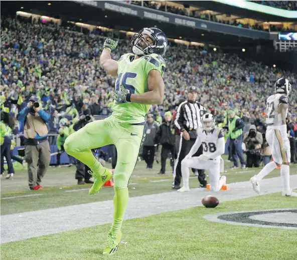  ?? — GETTY IMAGES FILES ?? Seattle wide receiver Tyler Lockett, who weighs in at just 170 pounds, celebrates after hauling in a 57-yard touchdown pass against the Rams on Thursday night. Lockett hasn’t let his small stature limit the size of his contributi­ons to the Seahawks’...