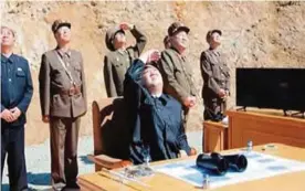  ??  ?? This image shows North Korea leader Kim Jung Un (center) watching the launch of a Hwasong-14 interconti­nental ballistic missile, ICBM, in North Korea’s northwest. —AP
