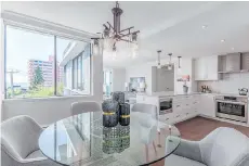  ??  ?? This two-bedroom, two-bathroom Bellevue Avenue home in West Vancouver features wraparound ocean and city views and an outdoor swimming pool.