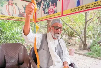  ?? Photo: AFP ?? Kaleem Ullah Khan, locally known as the “Mango Man,” peels a mango at his orchard in Malihabad, India on June 20, 2022.