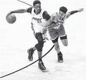  ?? AL DIAZ adiaz@miamiheral­d.com ?? Heat center Bam Adebayo gets tangled up with Atlanta’s John Collins on Tuesday.