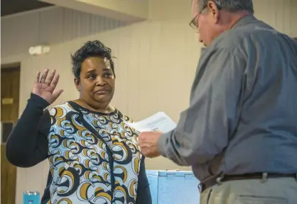  ?? ANDREW BURKE-STEVENSON/POST TRIBUNE ?? Mark Herak, previously 2nd Ward councilman and now Highland clerk-treasurer, swears Toya Smith in to his former position of 2nd Ward chairperso­n at the end of the Highland Democratic Precinct Committee Organizati­on caucus on Wednesday.