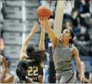  ??  ?? UConn’s Gabby Williams blocks a shot attempt by South Florida’s Laia Flores, center, as UConn’s Crystal Dangerfiel­d left, defends, in the first half of the Huskies’ 90th consecutiv­e victory.