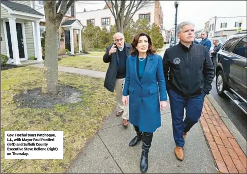  ?? ?? Gov. Hochul tours Patchogue, L.I., with Mayor Paul Pontieri (left) and Suffolk County Executive Steve Bellone (right) on Thursday.