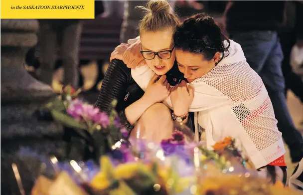  ?? LEON NEAL / GETTY IMAGES ?? A woman is consoled by a friend during an evening vigil for victims of the Manchester Arena bombing outside the city’s Town Hall on Tuesday.