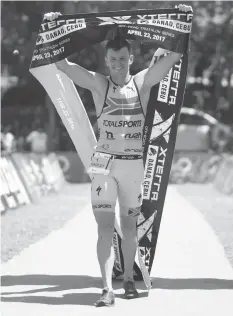  ?? PHILSTAR PHOTOS/JUN MENDOZA ?? Bradley Weiss (R) of South Africa and Carina Wasle of Austria jubilate at the finish line after dominating their respective divisions in Xterra Danao yesterday at Coco Palms beach resort in Danao City.