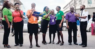  ?? CONTRIBUTE­D PHOTOS ?? A choir from the Jamaica Customs Agency participat­ing in the Accountant General’s Department’s Carols in the City activity in downtown Kingston on December 14.