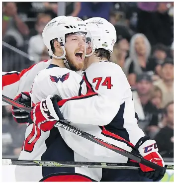  ?? HARRY HOW/GETTY IMAGES ?? Lars Eller, left, gets a hug from John Carlson after scoring Washington’s first goal Wednesday in a 3-2 win over the Golden Knights in Game 2 of the Stanley Cup final at T-mobile Arena in Las Vegas.