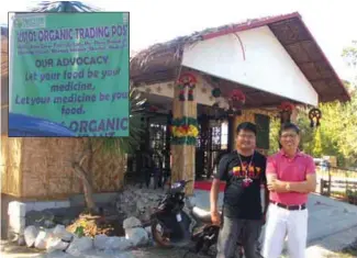  ??  ?? Markvic Tancangco with Art Veneracion in front of the permanent store of the Organic Trading Post. (Inset): Their advocacy is clearly stated in their tarpaulin signage.