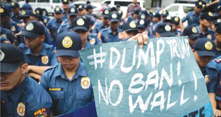  ??  ?? MANILA: An activist holds an anti-US banner during a protest in front of the US embassy in Manila yesterday.