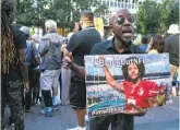  ?? Craig Ruttle / Associated Press ?? Eric Hamilton of New York joins others gathered outside NFL headquarte­rs in New York City in support of unsigned quarterbac­k Colin Kaepernick.