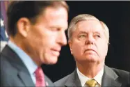  ?? Jim Watson / AFP/ Getty Images ?? Sens. Lindsey Graham, R-S.C., right, and Richard Blumenthal, D-Conn., reveal a proposal to open up federal courts nationwide for protective orders to temporaril­y seize weapons from potential mass shooters on Capitol Hill in Washington, D.C., on Thursday.