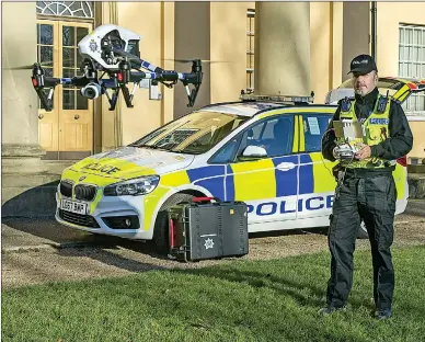  ??  ?? AIR SHOW: A specially trained police officer uses a drone, which can take aerial videos or photograph­s