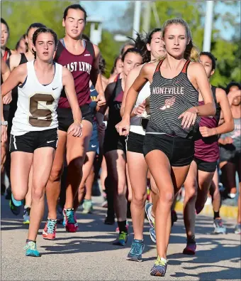  ?? TIM MARTIN/THE DAY ?? Montville’s Mady Whittaker, right, leads the pack during the start of Tuesday’s quad-meet at Stonington. Whittaker went on to win the race while the East Lyme girls went 3-0.