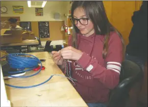  ?? JOHN BAYS/NEWS-SENTINEL ?? Above: Eighth-grader Hattie Ellison, 13, threads wires for an underwater remote-operated vehicle in her STEM class at Elkhorn Elementary School in Stockton on Friday. Left: Eighth-grader Alex Vega-Jimenez shows Lodi Unified School District board member...