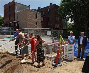  ?? Will Waldron / Times Union ?? Partners in developmen­t of the Hillside Views Neighborho­od Revitaliza­tion housing program break ground on Tuesday in Troy.