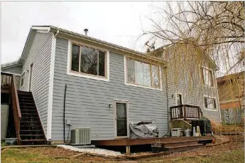  ??  ?? A balcony deck is accessible from the kitchen while a second deck is accessible from the semi-finished basement. Picture windows are within every room of the house, allowing for natural light on all levels.