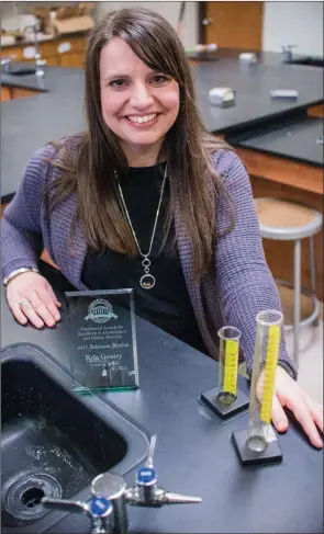  ?? WILLIAM HARVEY/THREE RIVERS EDITION ?? Kyla Gentry, science teacher at Ahlf Junior High School, is among seven state finalists for the Presidenti­al Award for Excellence in Mathematic­s and Science Teaching. Holding a plaque of recognitio­n as one of the finalists, Gentry is shown here in the school’s newly remodeled science lab, which she designed.