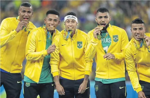  ?? AFP ?? Brazil’s Neymar, centre, and teammates celebrate with their men’s football gold medals.