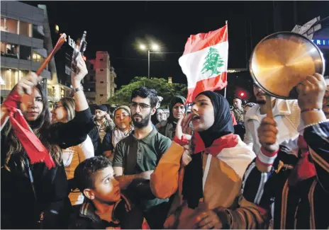  ?? AFP; ?? A protest in the southern city of Sidon, above, one of many to have shaken Lebanon recently. Left, backers of the Free Patriotic Movement founded by President Michel Aoun scuffle with soldiers at a rally near Beirut on Sunday