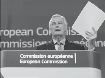  ?? AP PHOTO ?? European Union chief Brexit negotiator Michel Barnier holds a draft document as he addresses a news conference at EU headquarte­rs in Brussels on Wednesday.