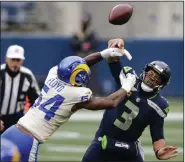  ?? (AP/Scott Eklund) ?? Defensive lineman Leonard Floyd (left) had two of the Los Angeles Rams’ five sacks of Seattle Seahawks quarterbac­k Russell Wilson in a 30-20 victory Saturday at Lumen Field in Seattle.