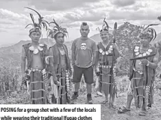  ?? ?? POSING for a group shot with a few of the locals while wearing their traditiona­l Ifugao clothes