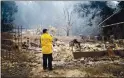  ?? COURTESY OF GINA ORLANDO ?? Veteran firefighte­r David Serna surveys his property after the CZU August Lightning Complex Fire destroyed his home on Swanton Road just north of Davenport.