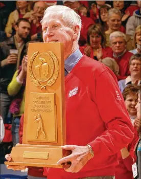  ?? TIMOTHY BOONE / STAFF ?? Former coach Don Donoher shows off the 1967 NCAA runner-up trophy at a ceremony in UD Arena. The Flyers followed with an NIT title in 1968.