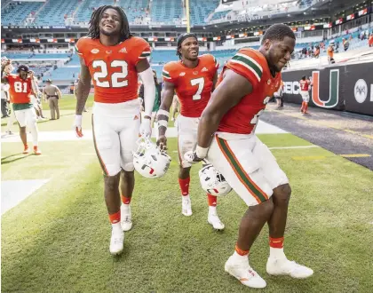  ?? AL DIAZ adiaz@miamiheral­d.com ?? UM defensive end Quincy Roche, right, celebrates a fumble recovery in last week’s win against Pittsburgh along with Cam Williams (22) and Al Blades Jr. The Hurricanes are enjoying their 4-1 start but are well aware they must continue to improve to climb higher in the rankings.